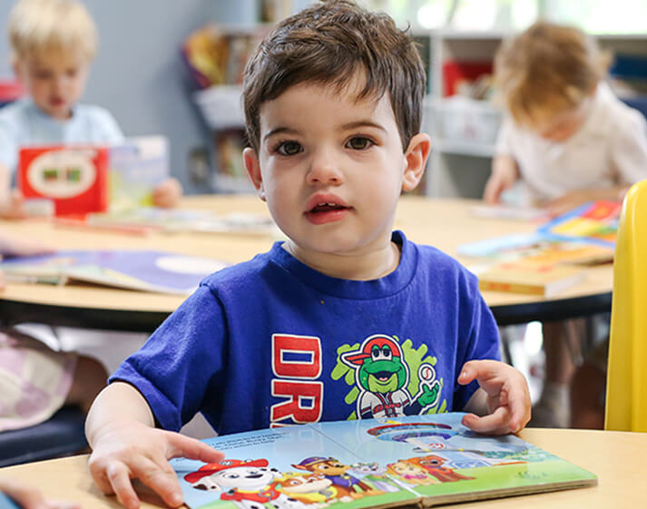 Child at table with book